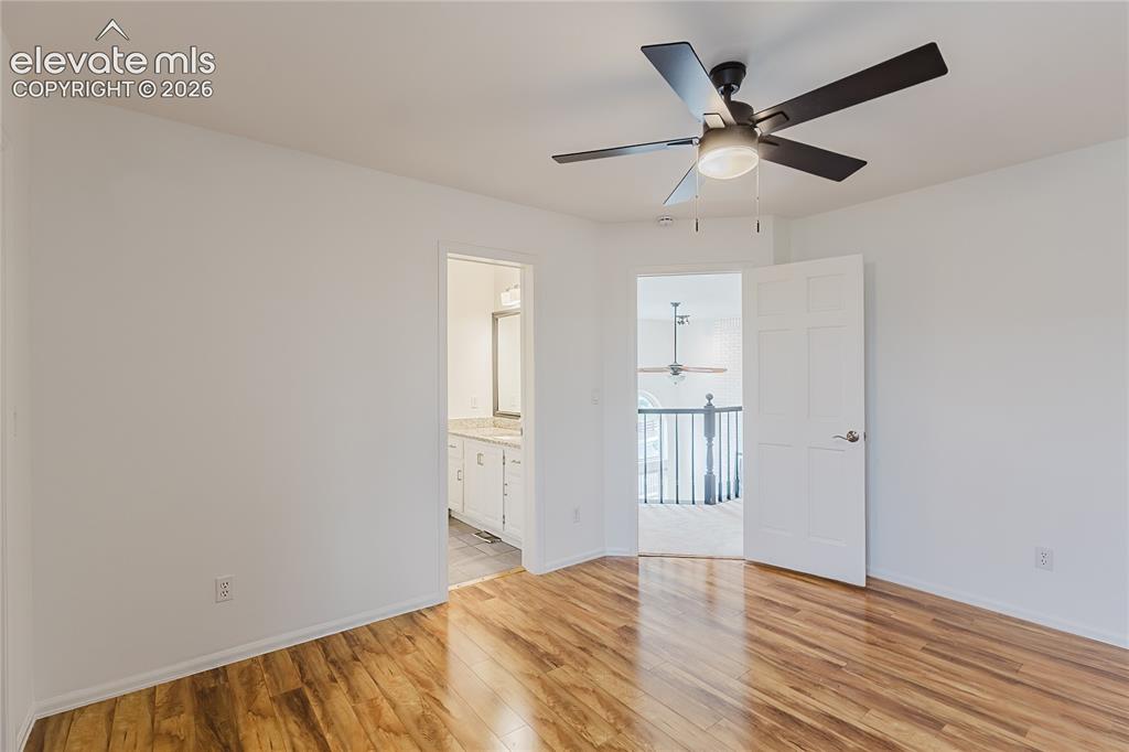 Image 16 of 34: Wood floors and attached jack-and-jill bathroom