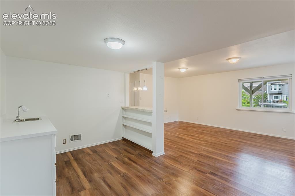 Image 25 of 34: Additional bedroom in basement with wet bar, perfect for a mother-in-law su