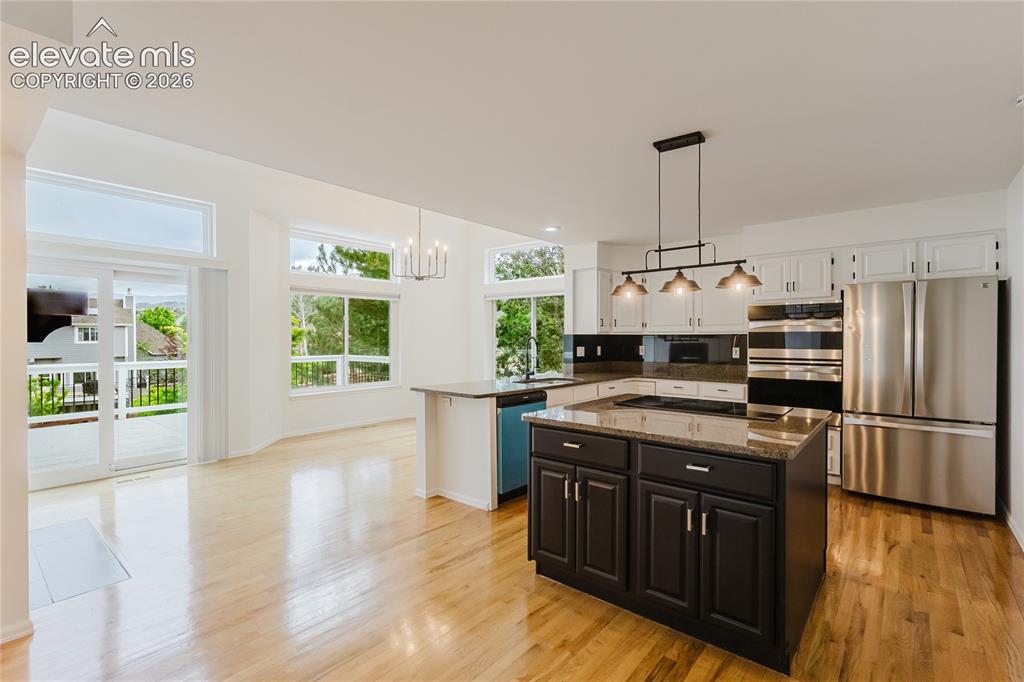 Image 7 of 34: Separate dining area off kitchen with walkout to large deck