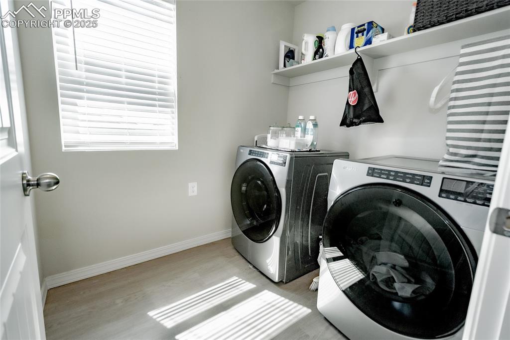 Image 14 of 25: Laundry room featuring washer and clothes dryer