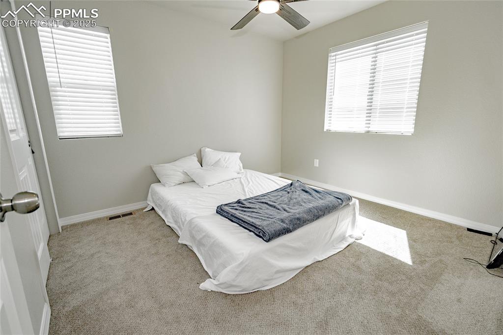 Image 16 of 25: Bedroom with a ceiling fan