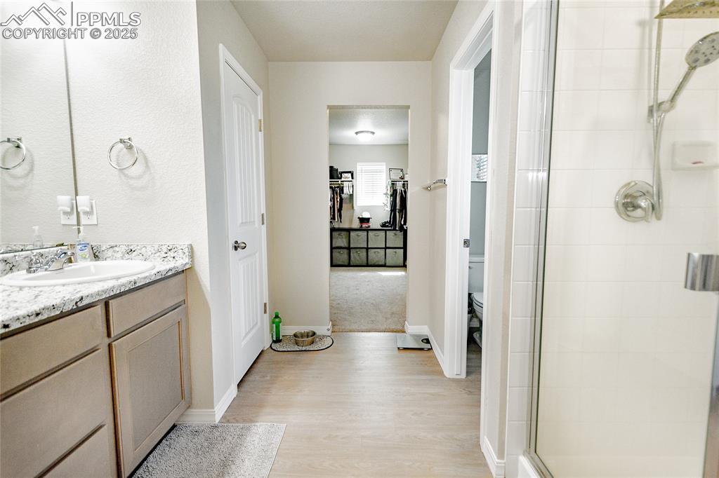 Image 19 of 25: Master ensuite with double vanity, water closet, and shower