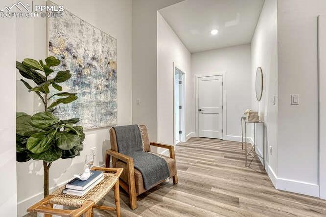Image 12 of 26: Living area featuring light wood-style flooring and recessed lighting