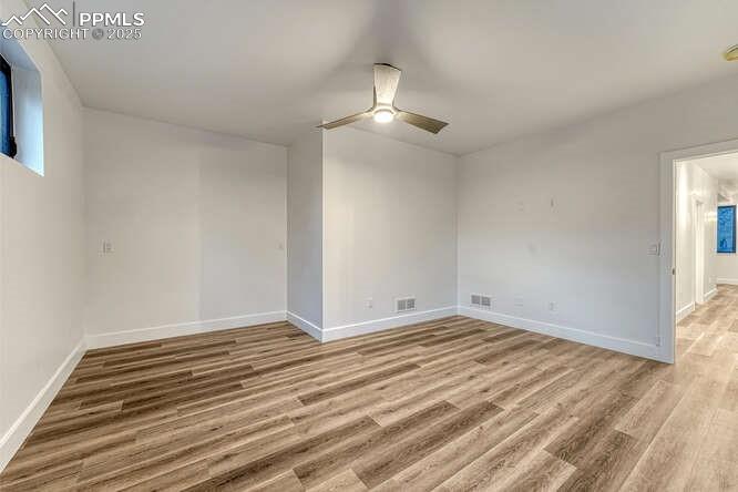 Image 14 of 26: Spare room featuring ceiling fan and light wood-style floors