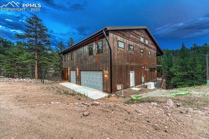 Image 15 of 26: View of side of property with dirt driveway