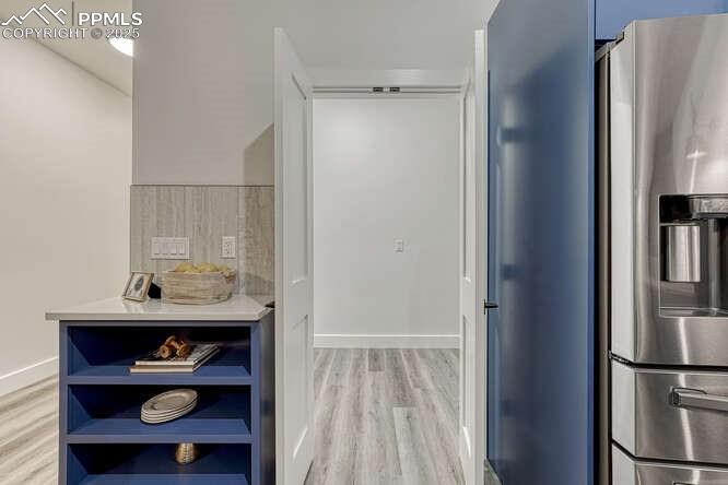 Image 24 of 26: Bathroom featuring wood finished floors and baseboards