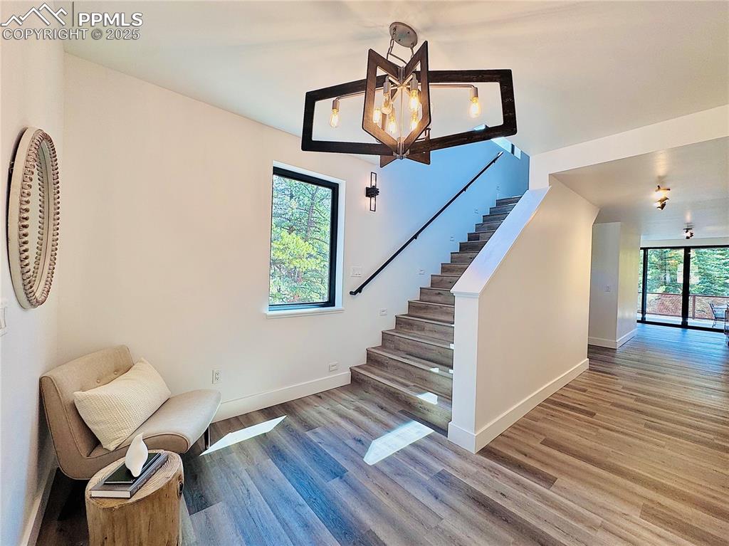 Image 3 of 26: Cozy entryway leading either to upstairs or non-conforming room and wet bar