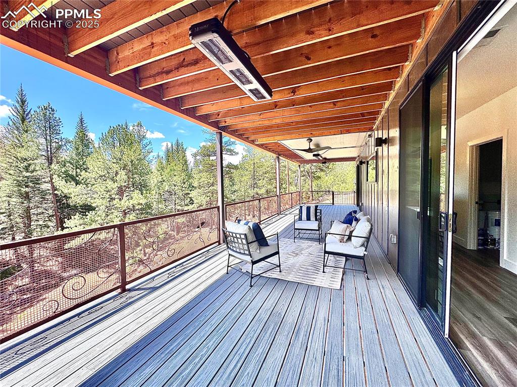 Image 4 of 26: Upper level deck with an outdoor living space and heater