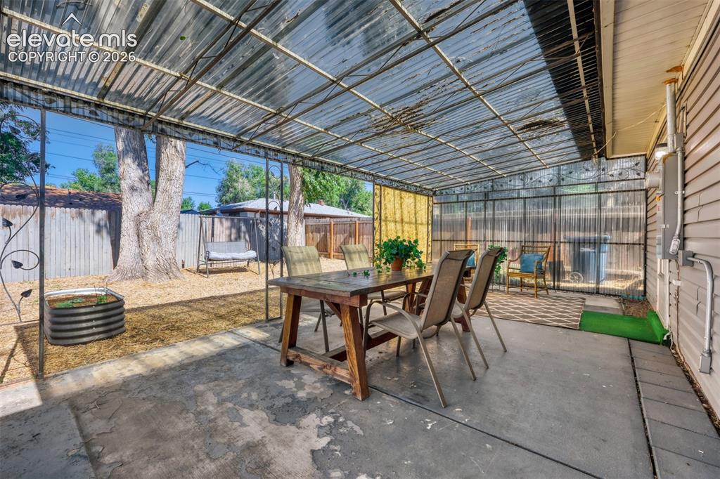 Image 19 of 20: Large covered area outside of dining room or from mudroom off of kitchen