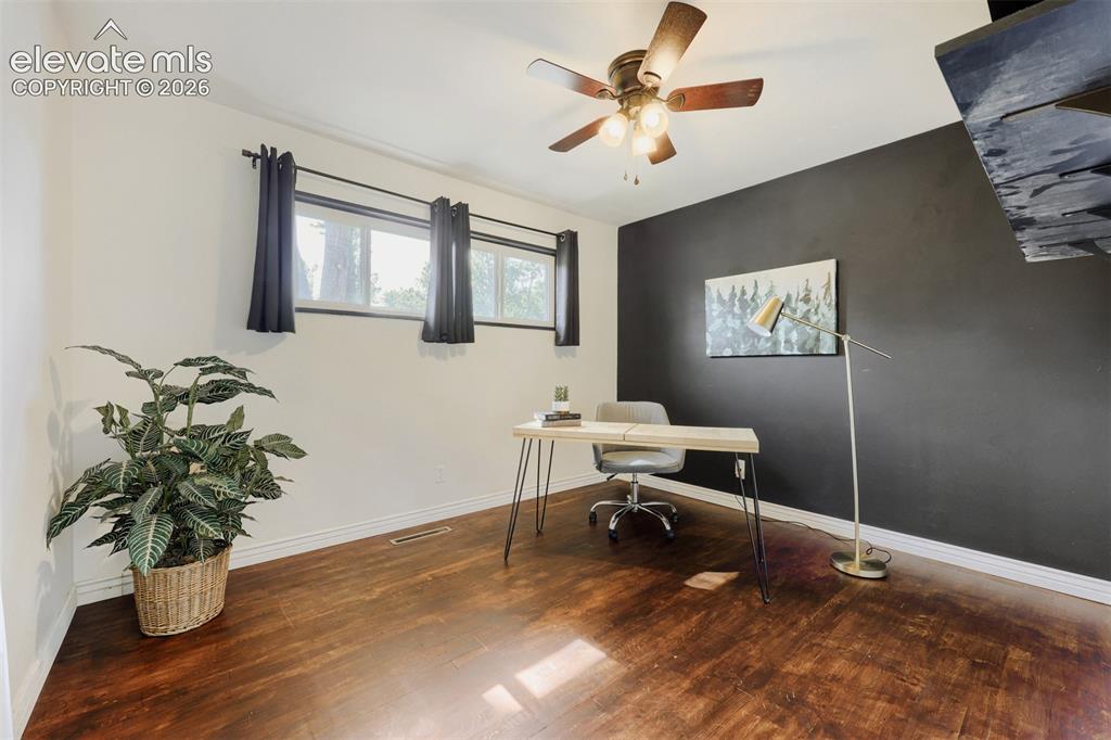 Image 9 of 20: Front bedroom with hardwood floors