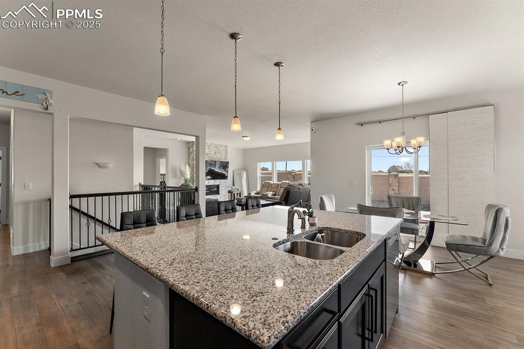 Image 19 of 46: Kitchen with stainless steel dishwasher, a sink, an inviting chandelier, a 