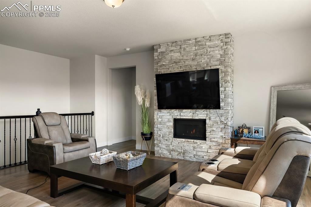 Image 20 of 46: Living area featuring a fireplace and wood finished floors