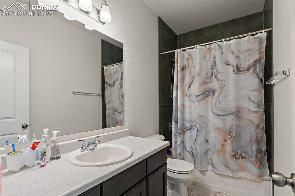 Image 35 of 46: Full bathroom featuring toilet, vanity, and shower / bathtub combination wi
