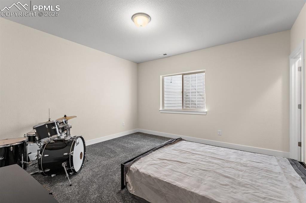 Image 36 of 46: Bedroom with carpet floors, visible vents, and baseboards