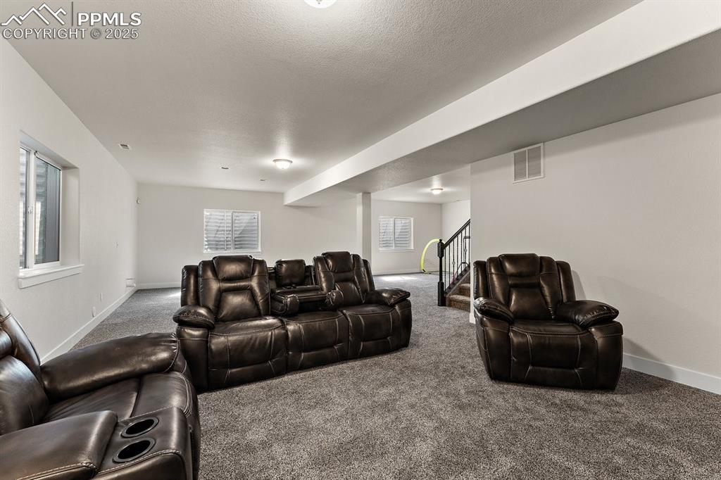 Image 40 of 46: Carpeted cinema room featuring visible vents and baseboards