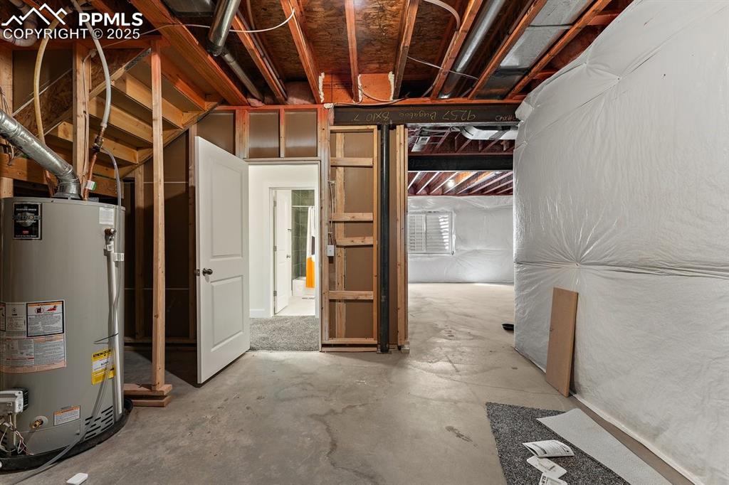 Image 42 of 46: Unfinished below grade area featuring gas water heater