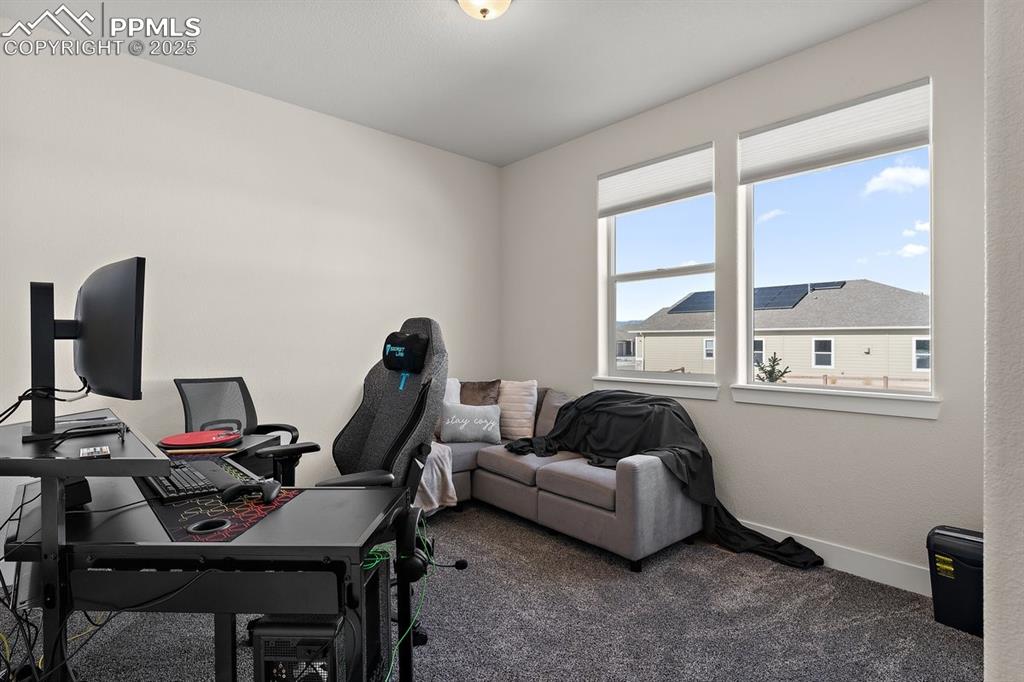 Image 8 of 46: Home office with carpet flooring and baseboards