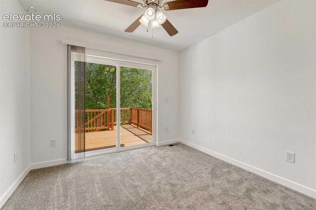 Image 18 of 50: Walk-out to deck from secondary bedroom!