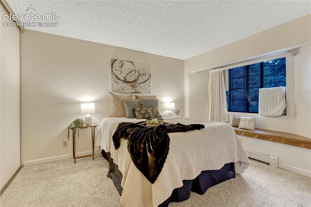 Image 14 of 50: The bedroom has a wonderful bench seating storage area- Reading books and l