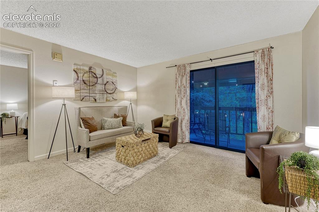 Image 3 of 50: The Living room walks out to a private balcony that overlooks the lush,quie