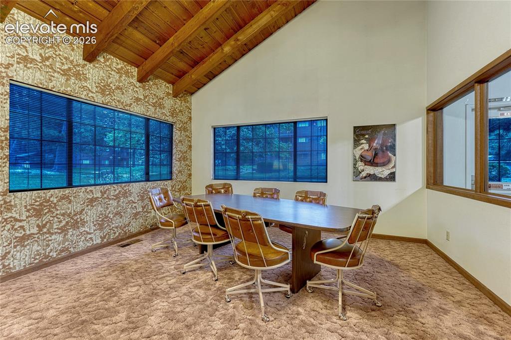 Image 35 of 50: Dining room/crafting area in the clubhouse overlooks the grounds and garden