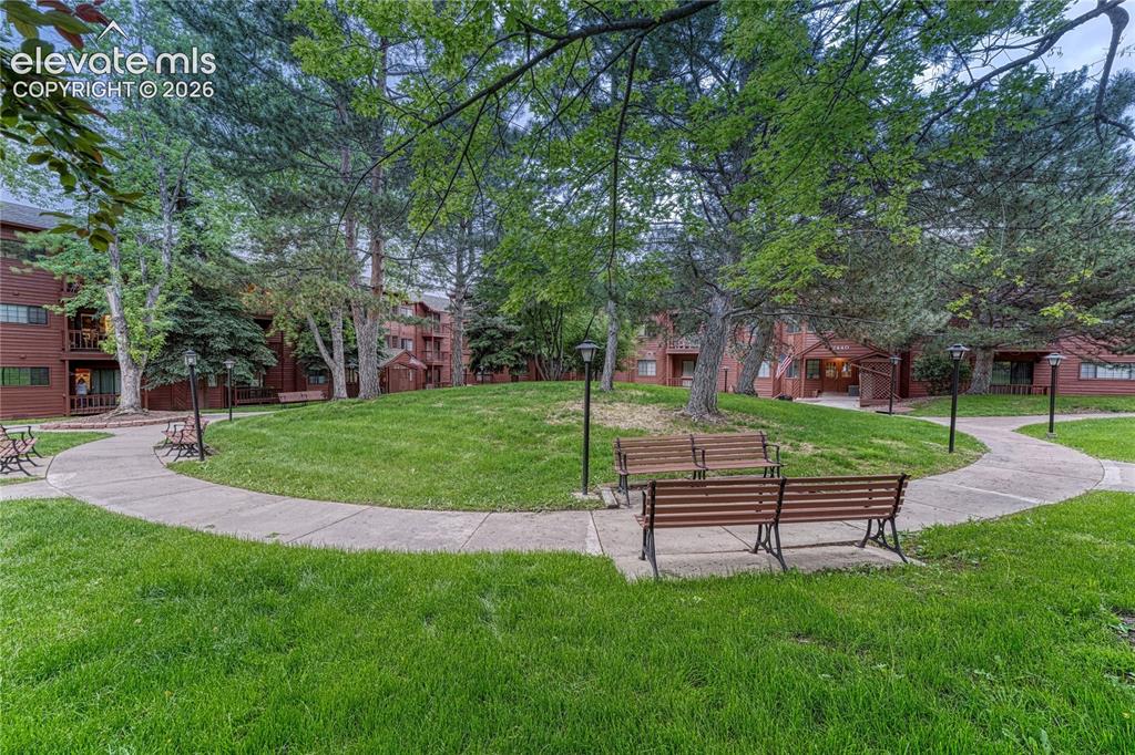 Image 4 of 50: walking paths and benches invite you to enjoy the outdoors and lush landsca