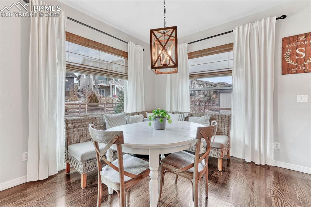 Image 23 of 44: Dining space featuring wood finished floors and baseboards