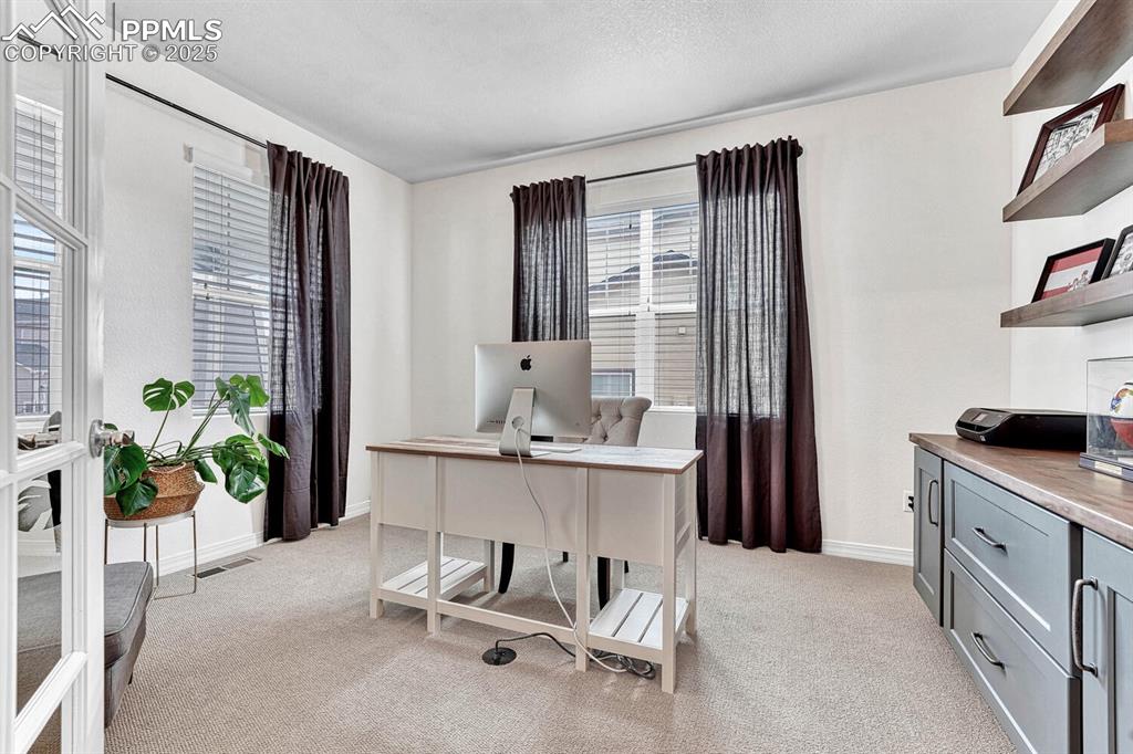 Image 3 of 44: Office area with baseboards, visible vents, and light carpet