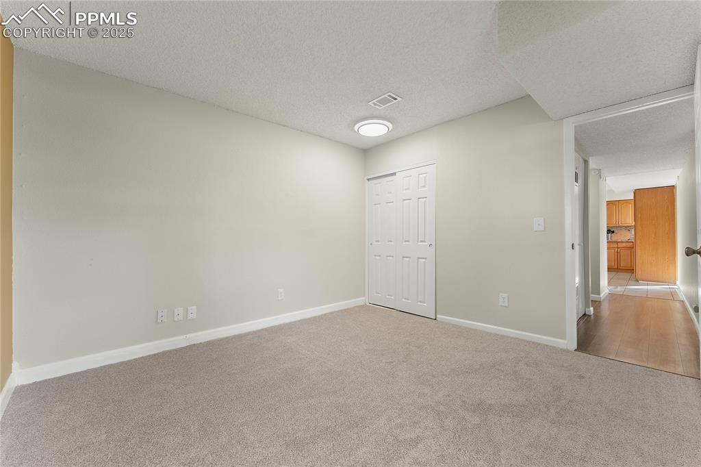 Image 12 of 33: Bedroom/office on main w/ closet, new carpet