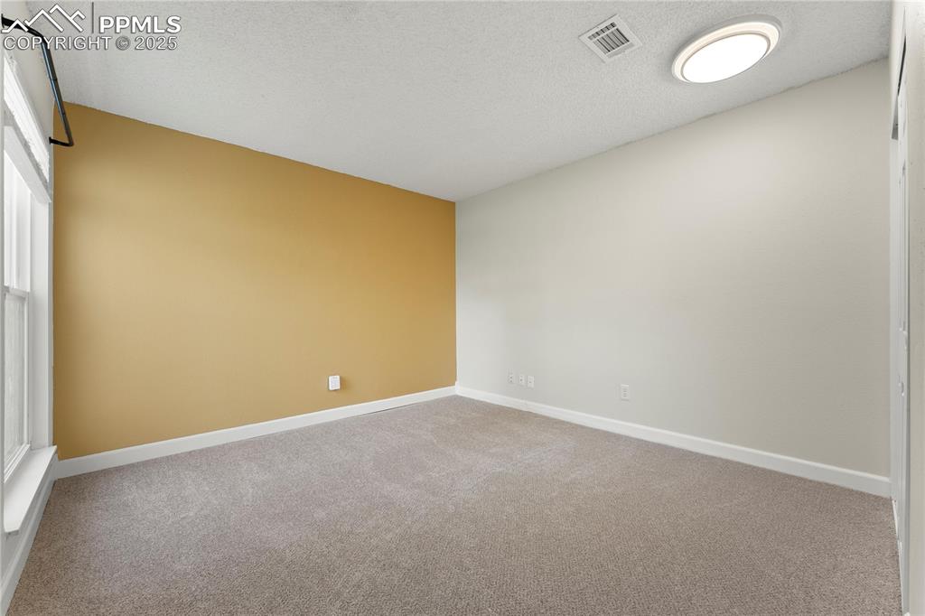 Image 13 of 33: Bedroom/office on main w/ closet, new carpet