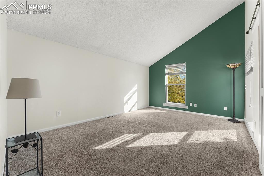 Image 14 of 33: Primary bedroom on 2nd floor with vaulted ceiling