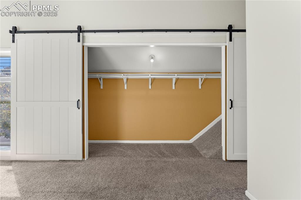 Image 17 of 33: View of closet in primary bedroom