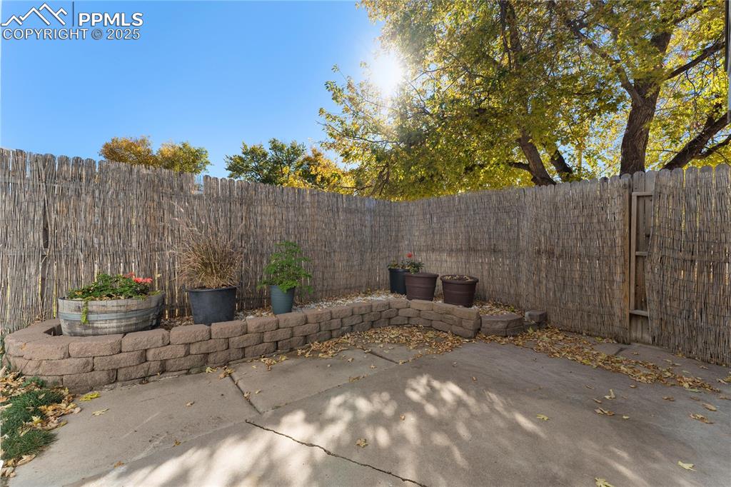 Image 25 of 33: Fenced backyard featuring a patio area