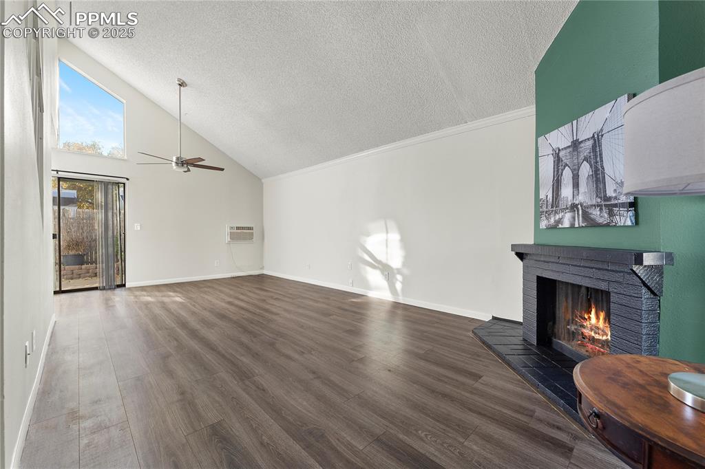 Image 3 of 33: Living room with vaulted ceilings, LVP, Ceiling fan over dining area