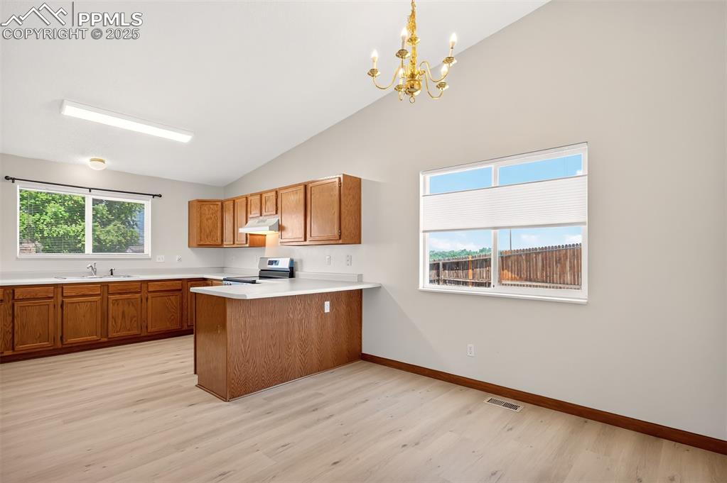 Image 12 of 23: Nice-sized dining area opens to the kitchen.