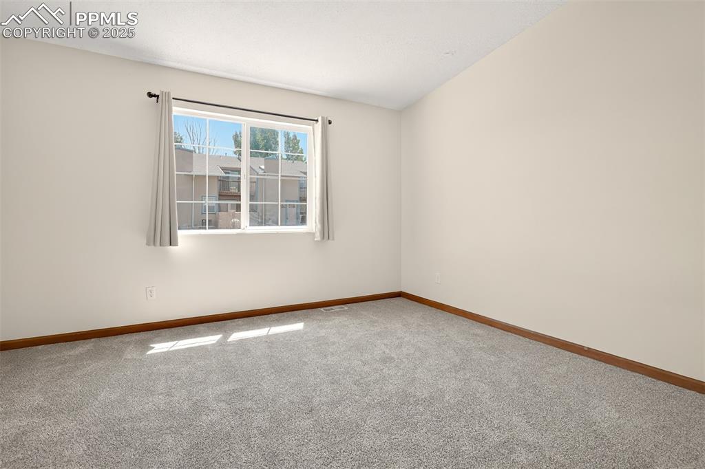 Image 14 of 23: Vaulted primary suite features and adjoining 3/4 bath and walk-in closet.