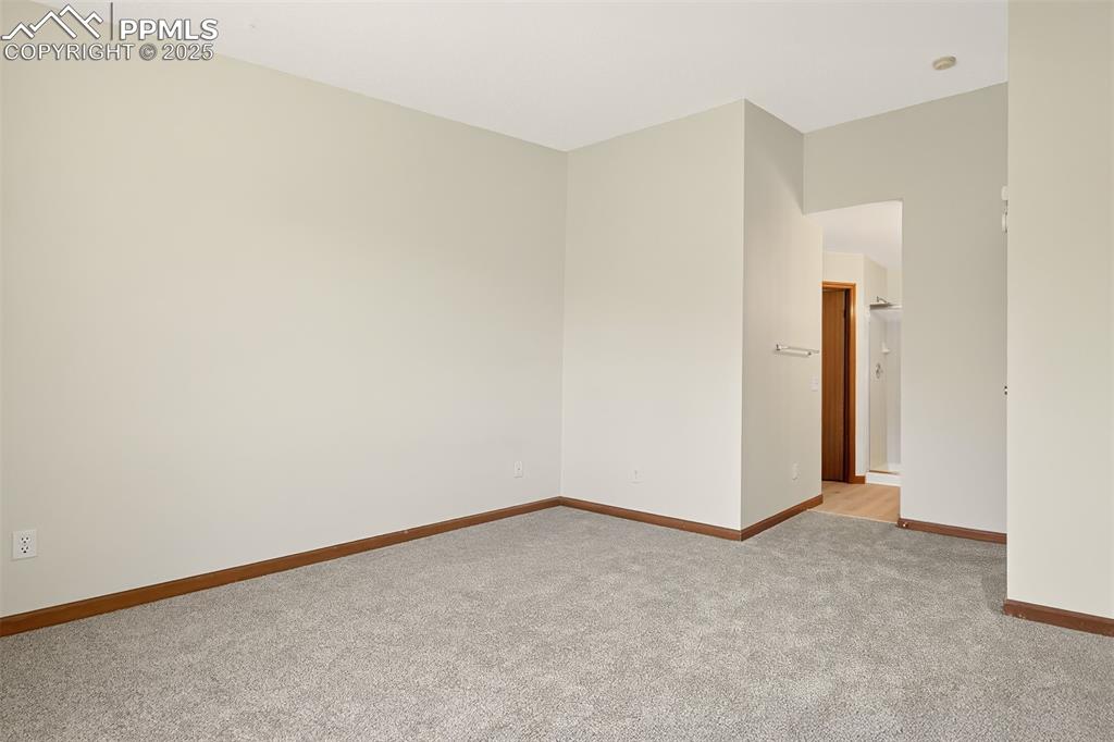 Image 15 of 23: Primary suite looking toward the adjoining bath.