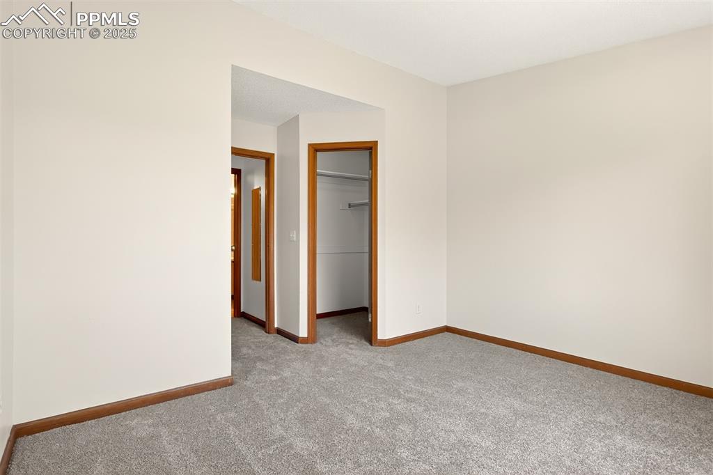 Image 18 of 23: Opposite view of the secondary bedroom looking toward the walk-in closet an