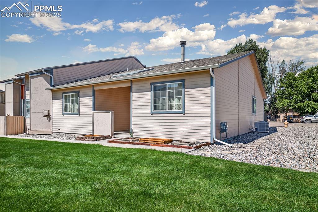 Image 2 of 23: Plenty of grass area in front of this charming end-unit ranch-style townhom