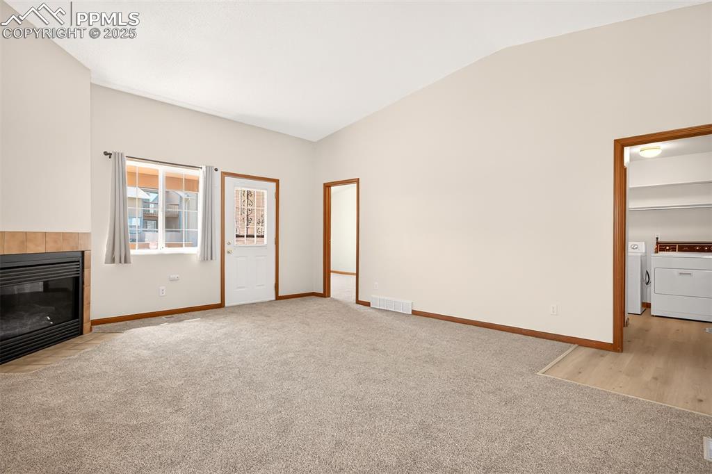 Image 7 of 23: Another view of the living room showing primary suite entrance (right of th