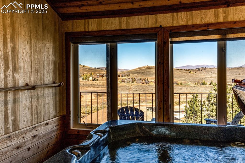 Image 23 of 42: Doorway to outside with wooden walls and a mountain view
