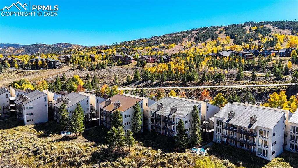Image 31 of 42: Aerial view of residential area with a mountain backdrop