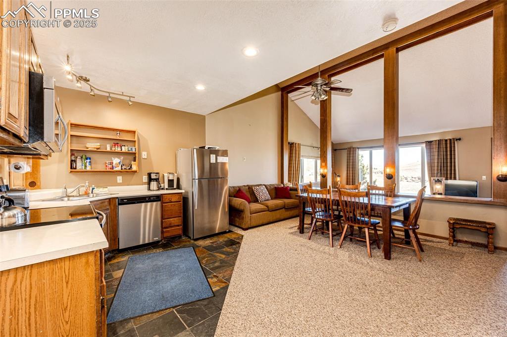 Image 4 of 42: Kitchen with light countertops, stainless steel appliances, lofted ceiling,