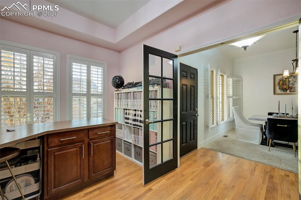 Image 10 of 50: Double doors and plantation blinds in the front office