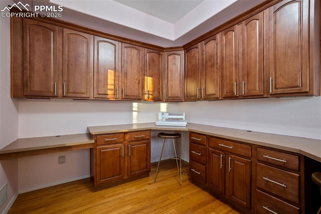 Image 12 of 50: Built-in cabinets and U shaped desk in the front office