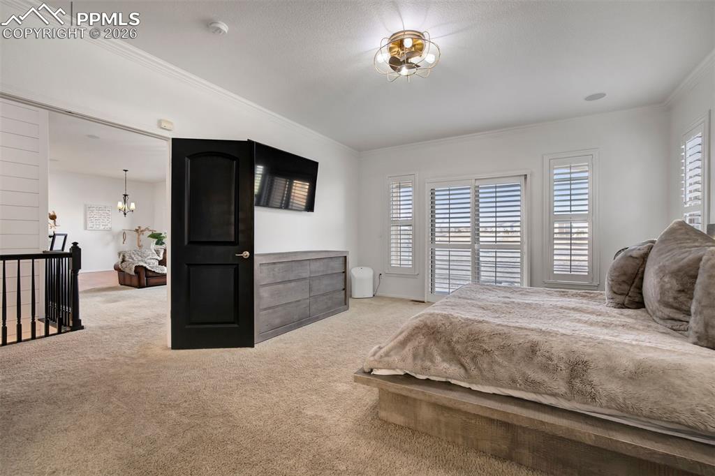 Image 22 of 50: Double doors leading to the primary bedroom. Sliding glass door from the be