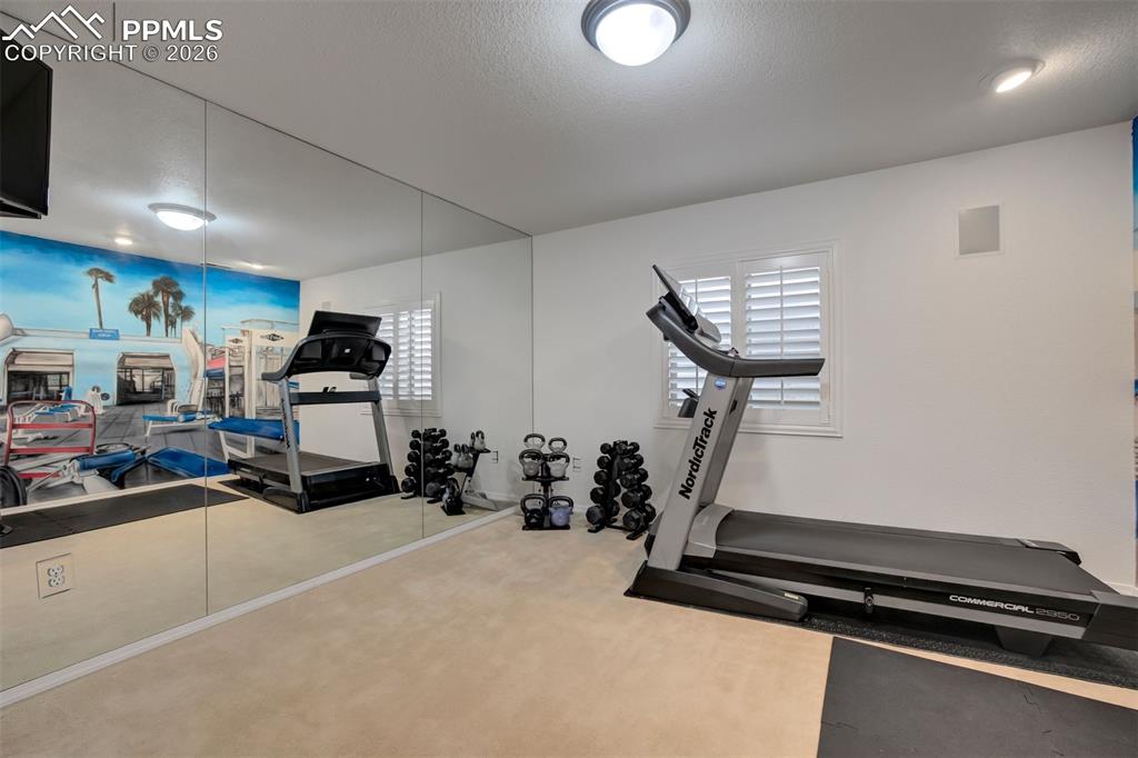Image 36 of 50: Wall of mirrors in the gym