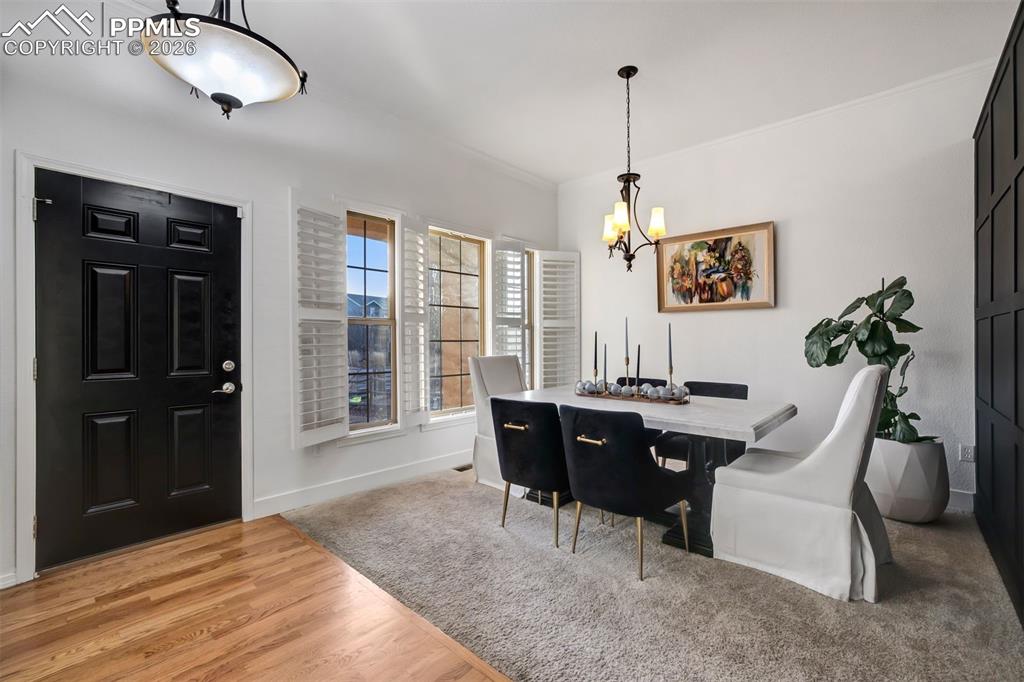 Image 5 of 50: Front room with plantation blinds and accent wall
