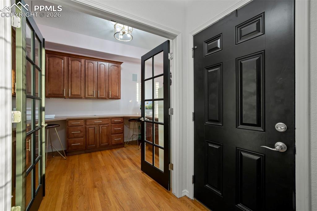 Image 9 of 50: Double doors lead to office