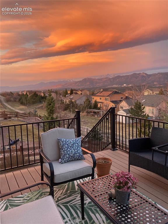 Image 43 of 49: Expansive outdoor deck featuring composite decking and black metal railings